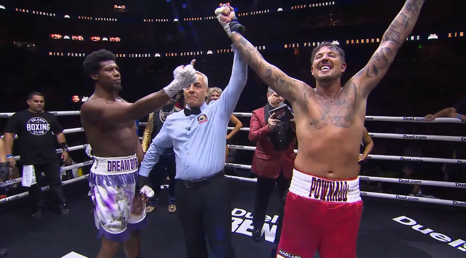 Referee raising Ryan Pownall's arm in the ring after Patrick Clark Jr was disqualified at Duel Arena 1